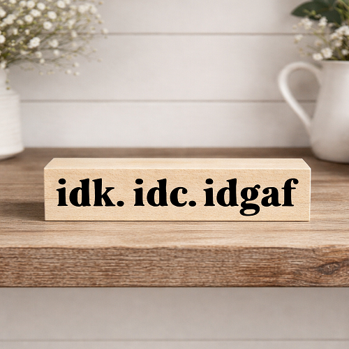 Funny desk sign that reads IDK IDC IDGAF 