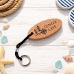 Personalized floating cork lake keychain with compass pine tree design and custom lake name on front 