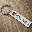 Never Give Up inspirational keychain with heart cutout and optional personalized message on back 