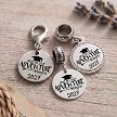 Personalized graduation year charm with And So Our Adventure Begins graduation cap design and optional back personalization 