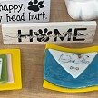 Home Is Where Your Cat Is sign with paw print design for cat moms, cat dads, cat lovers and pet families 